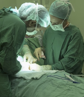 Doctors carrying out a c-section on a pregnant woman