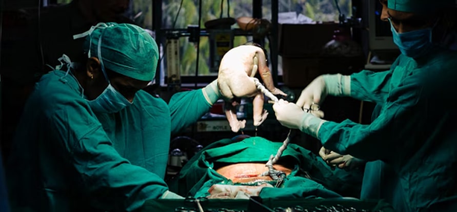 Doctor operating a pregnant woman