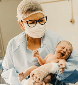 Doctor carrying a new born baby