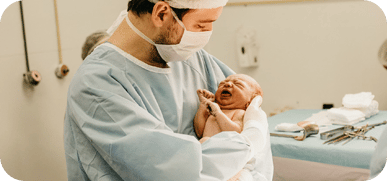Doctor carrying a newborn baby